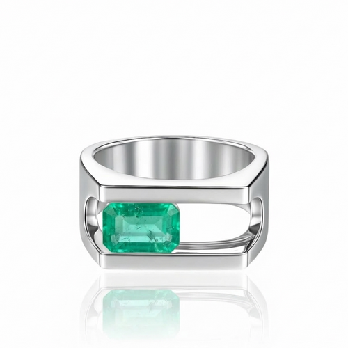 White gold signet ring with a moving emerald; ring shown on a white background