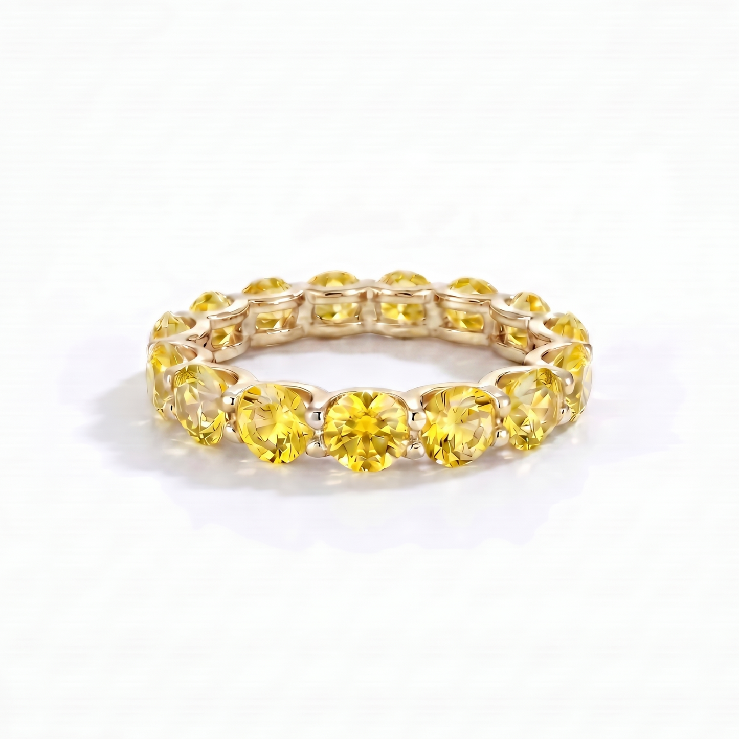 Eternity yellow gold ring with yellow sapphires on a white background