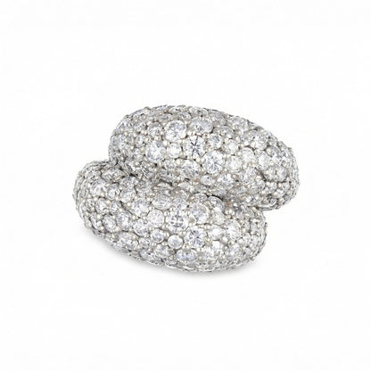 Large white gold and diamond fully pave knot ring on a white background 