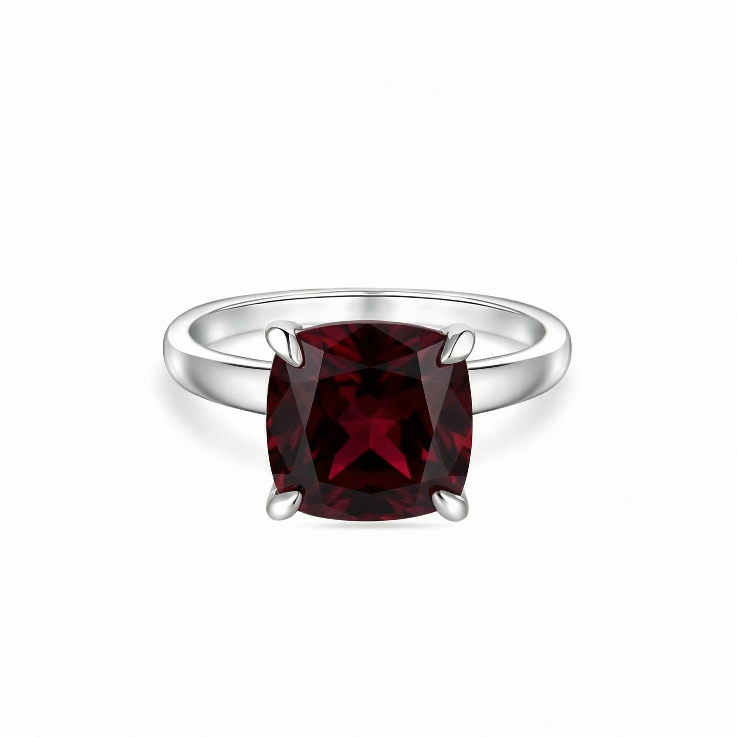 white gold ring with a dark red ruby - garnet tone on a white background