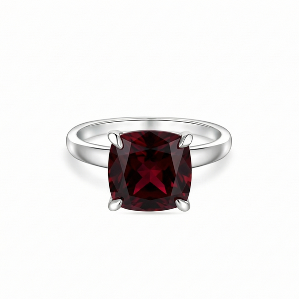 white gold ring with a dark red ruby - garnet tone on a white background