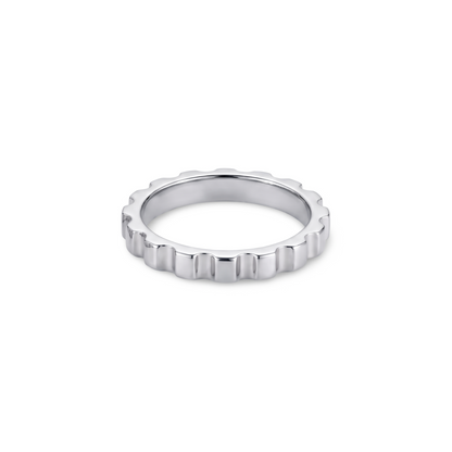 white gold ring with a textured band with ridges looking like a gear; ring is presented on a white background