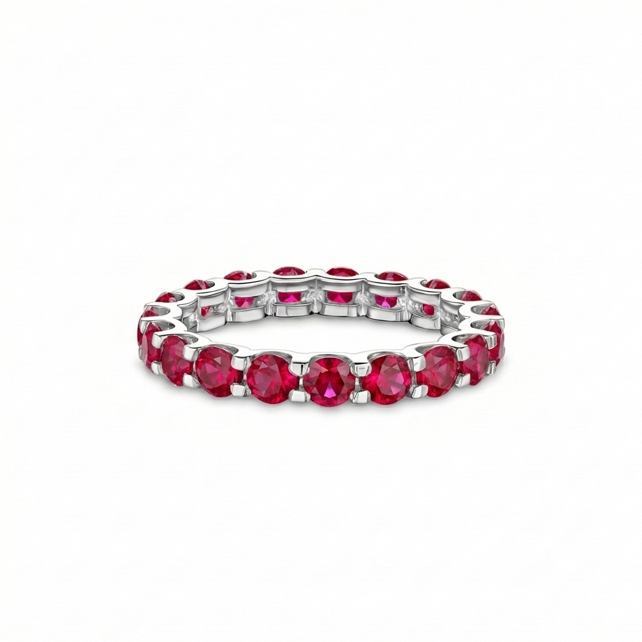 White gold eternity ring with red lab grown ruby on a white background