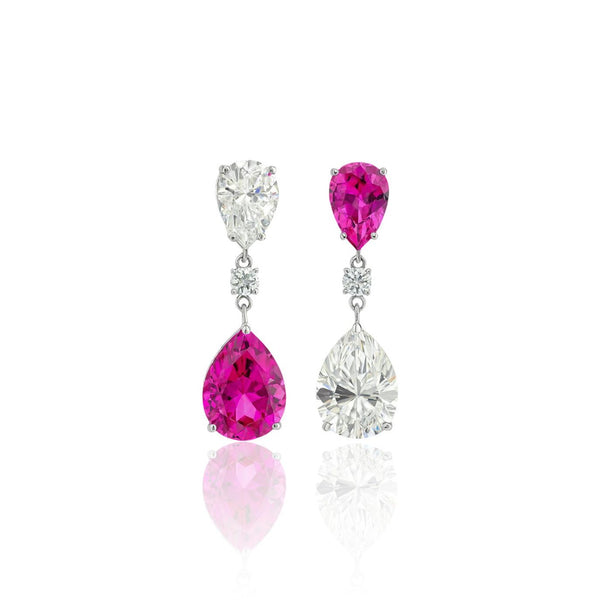 Pair of white gold drop earrings with vivid pink sapphires and diamonds on a white background. Lab grown gemstones. Fine jewellery by Atlas Carre